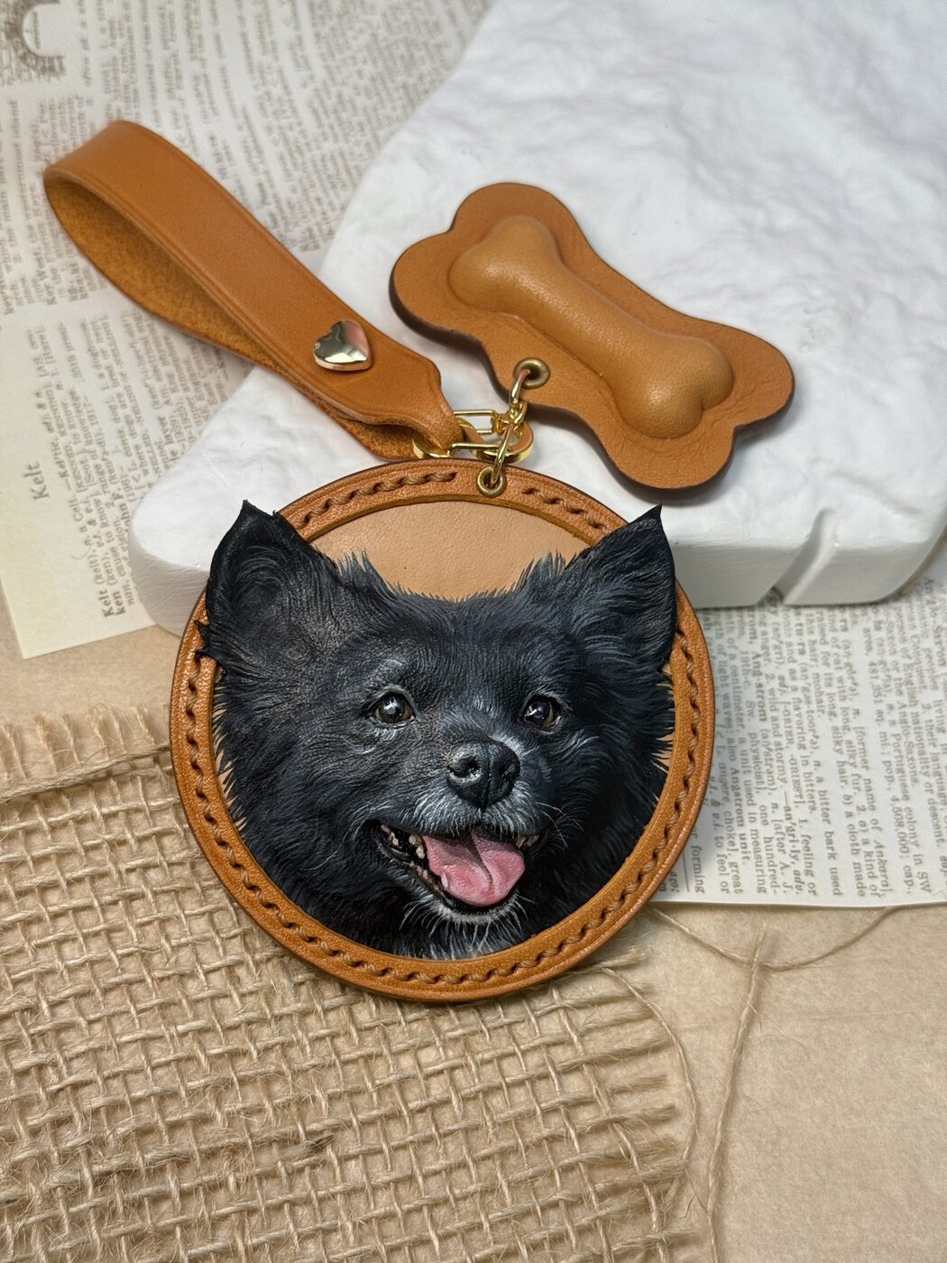Close view of a black dog portrait carved and painted on leather