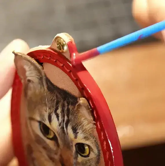 Applying a smooth finish to the edge of a leather pet portrait